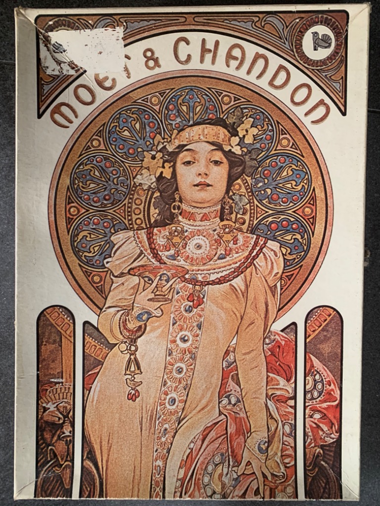 Art Nouveau illustration of a woman in a cream dress holding a champagne coupe, framed by an ornate circular mosaic backgroun