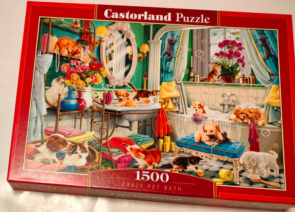 A bathroom scene filled with numerous kittens and puppies playing in and around a bathtub.
