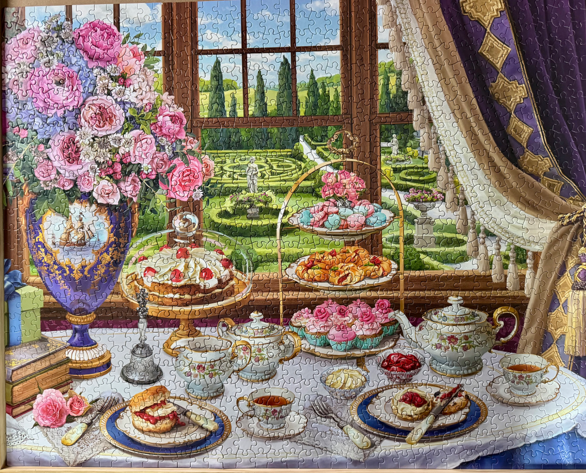 A formal afternoon tea scene set before a window looking out onto a manicured garden.
