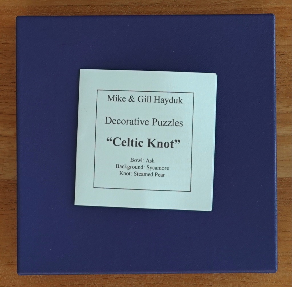 A square, dark blue surface with a centered white card containing text about a Celtic Knot artwork.