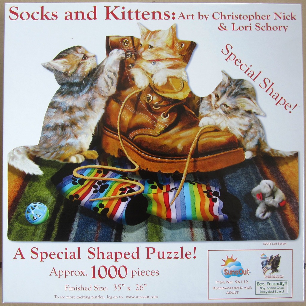 Illustration of three kittens playing with a brown leather boot and striped socks on a patterned rug.