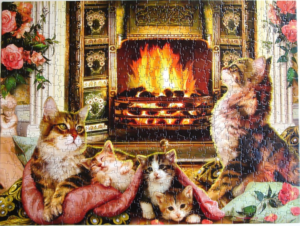 Four kittens cozying up in front of a warm, glowing fireplace