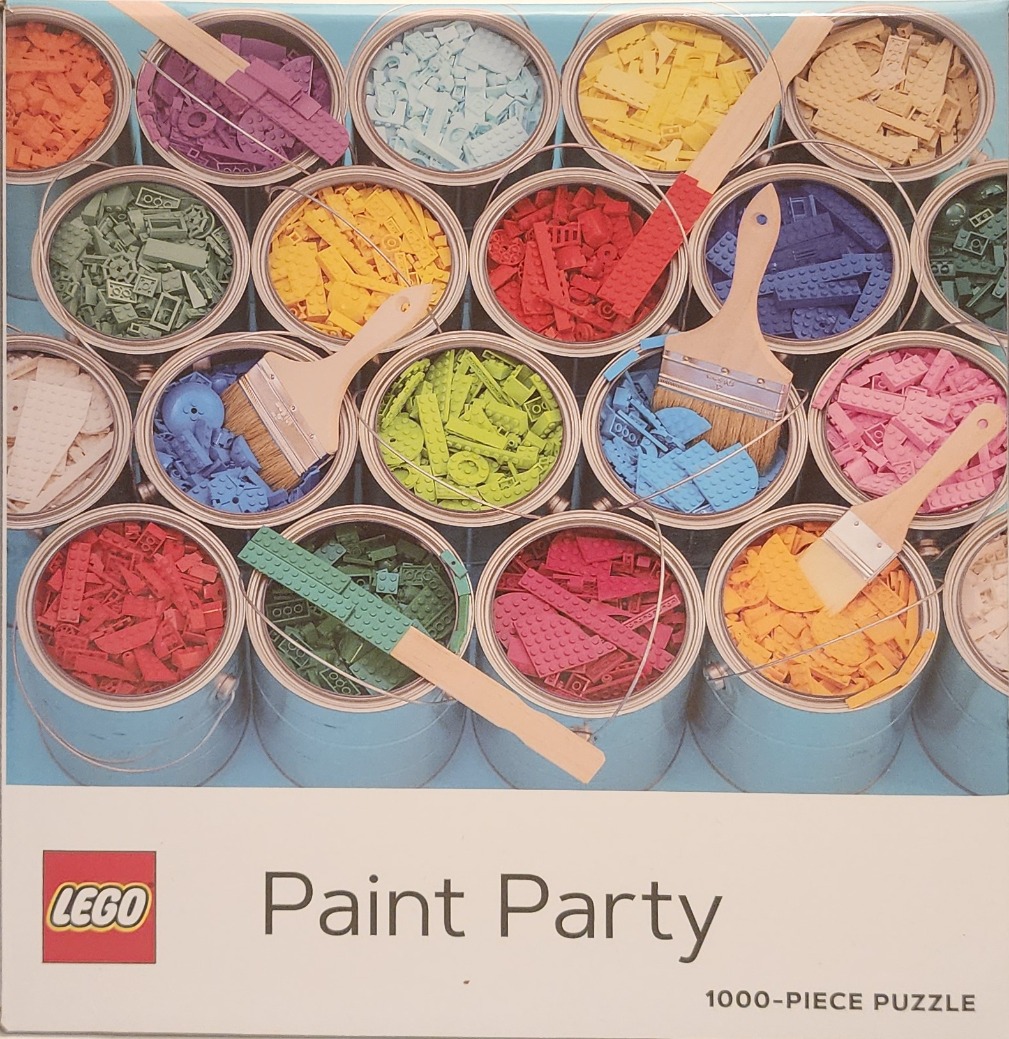 Top-down view of open paint cans filled with various colored plastic building bricks
