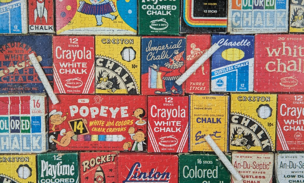 A collage of vintage colorful chalk boxes from various brands arranged in a grid pattern.