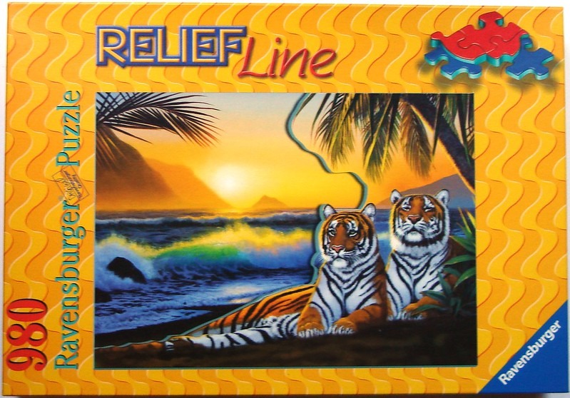 Two tigers resting on a beach at sunset with palm trees and ocean waves in the background.