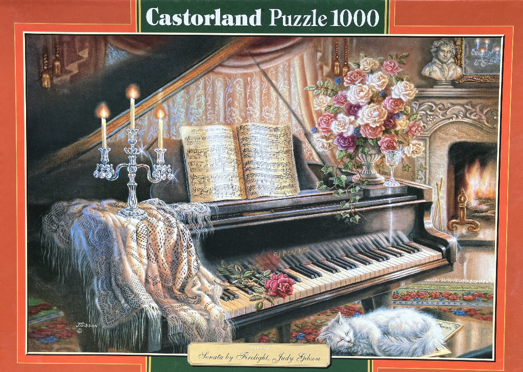 A black grand piano adorned with a crystal candelabra, lace, sheet music, and a floral bouquet in a room with a fireplace.