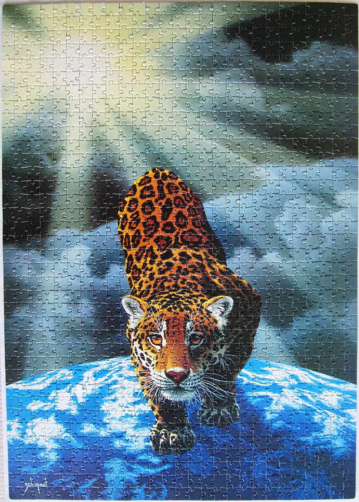 A spotted jaguar walks across the top of the Earth set against a cloudy, sunlit sky.