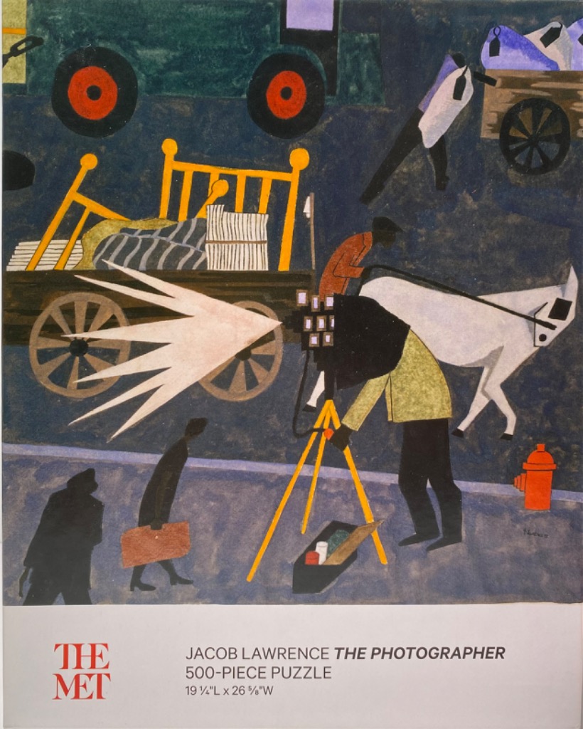 A stylized painting of a photographer under a cloth taking a picture of a street scene with carts and people.