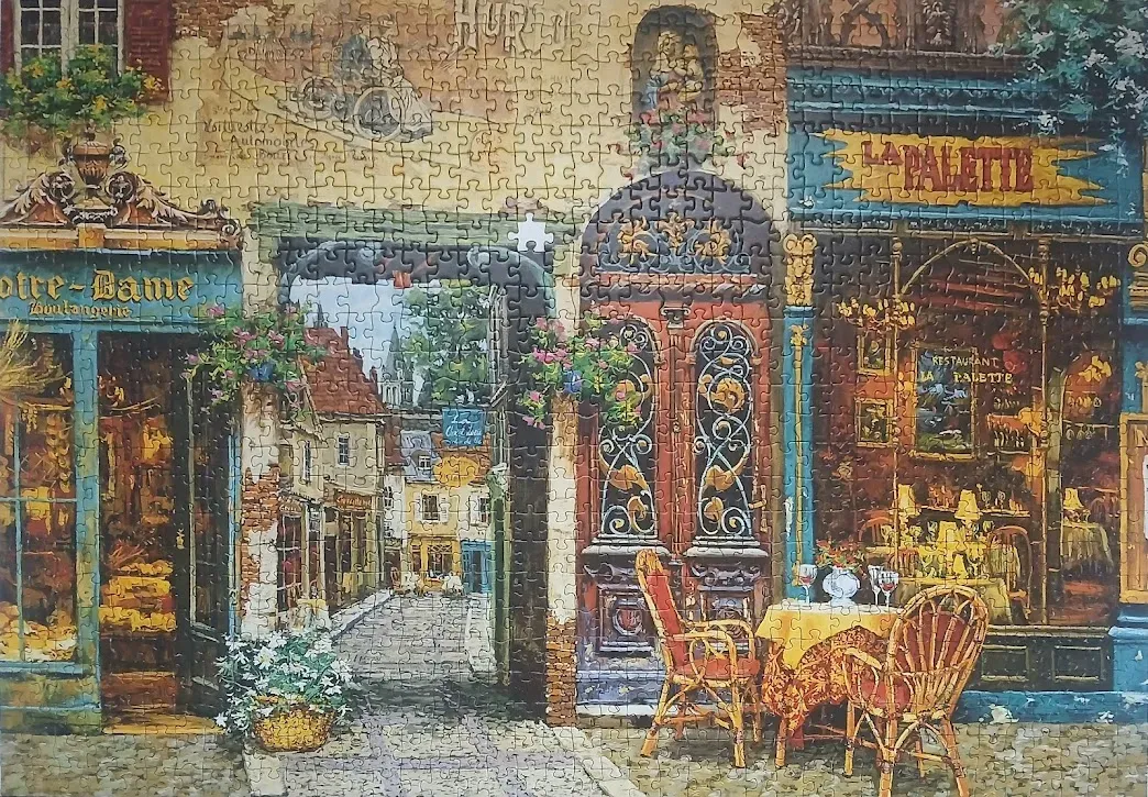 A detailed oil painting of a quaint European street featuring a bakery, a restaurant named La Palette, and stone arches.