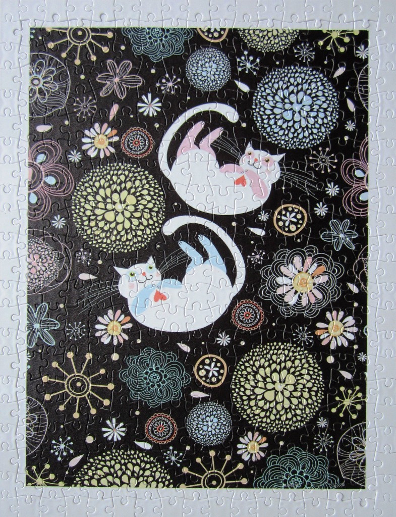 Whimsical illustration of two white cats playing amidst stylized, colorful floral patterns on a black background.
