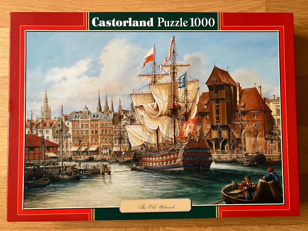 An oil painting of a historical sailing ship docked in the port of Gdansk, surrounded by traditional brick architecture.