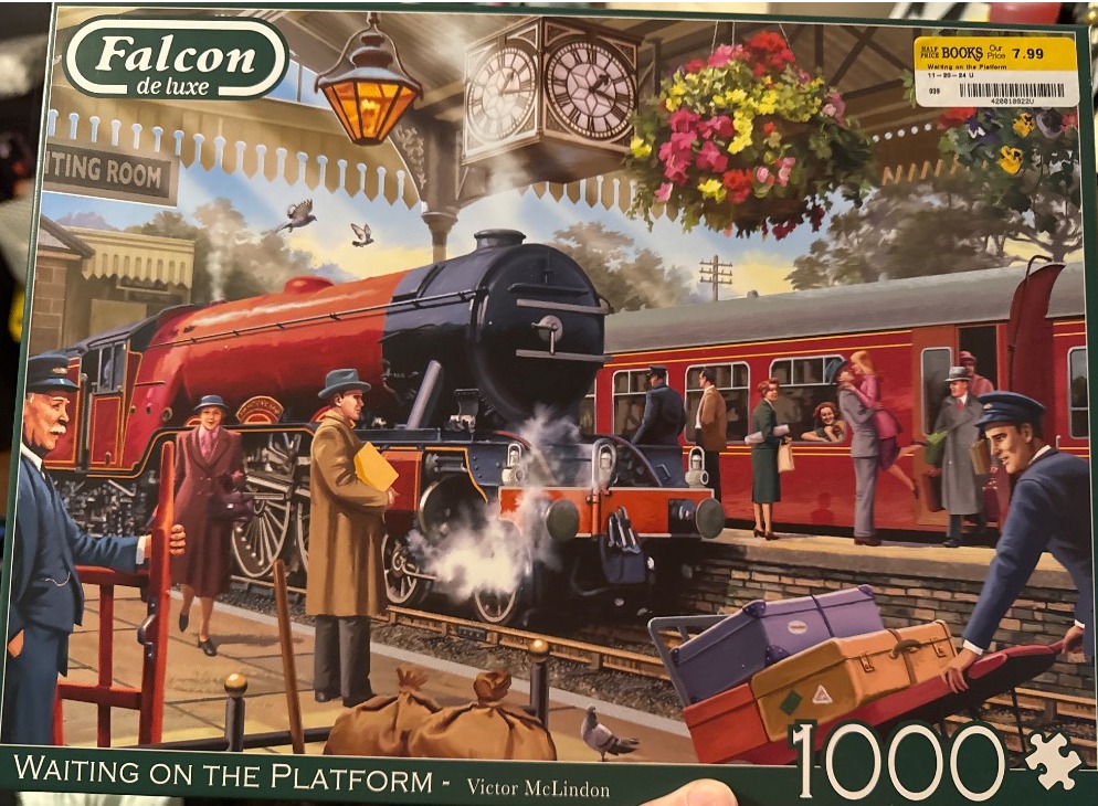 Vintage steam locomotive waiting at a busy train station platform with passengers in 1940s-style clothing.