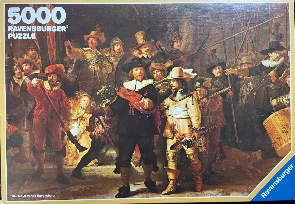 A reproduction of Rembrandt’s painting The Night Watch featuring a group of armed guards and figures in 17th-century attire