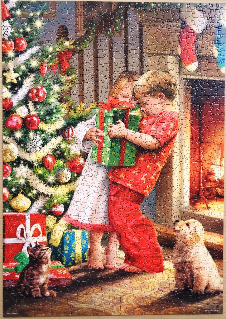Two children opening a Christmas gift beside a tree with a kitten and a puppy.