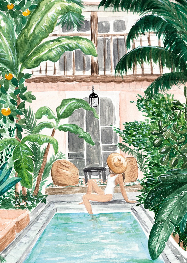 A woman in a straw hat and white swimsuit relaxes by a turquoise pool in a lush tropical courtyard.