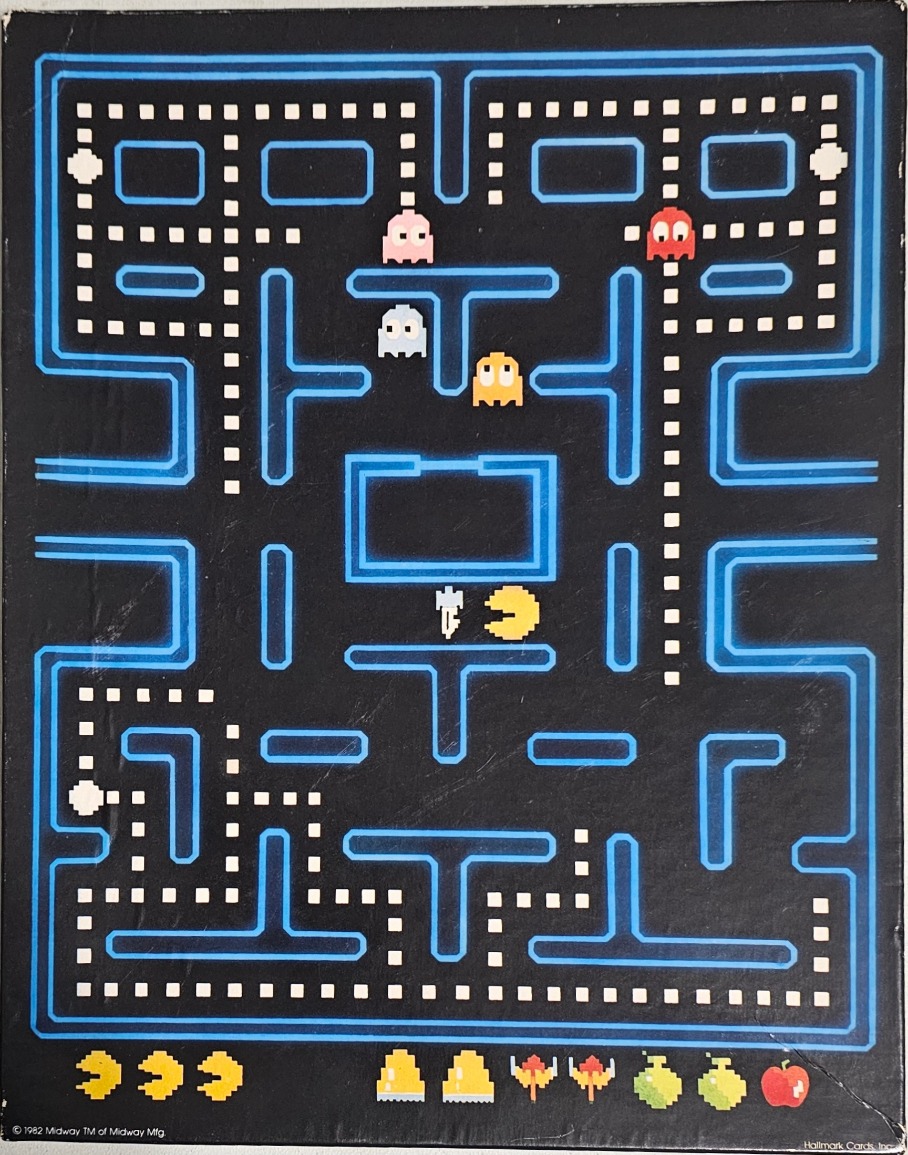 A classic 8-bit Pac-Man video game screen with a dark blue maze, ghosts, and dots on a black background.