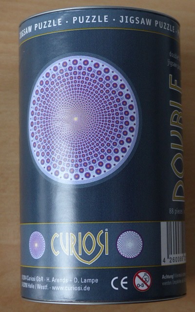 A spiral geometric pattern of purple and orange dots on a dark background.