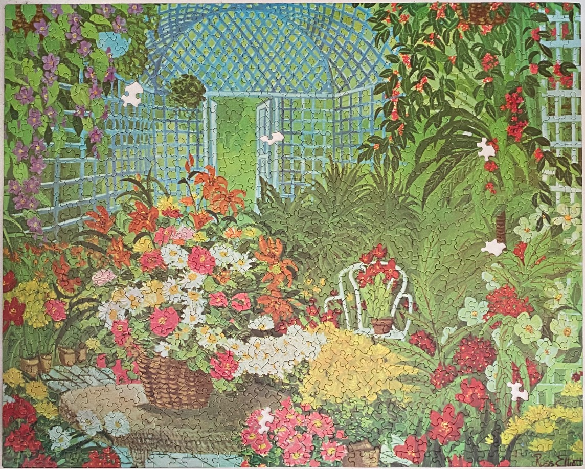 A lush, colorful garden scene with a central stone table, flower basket, and an arched garden trellis in the background.