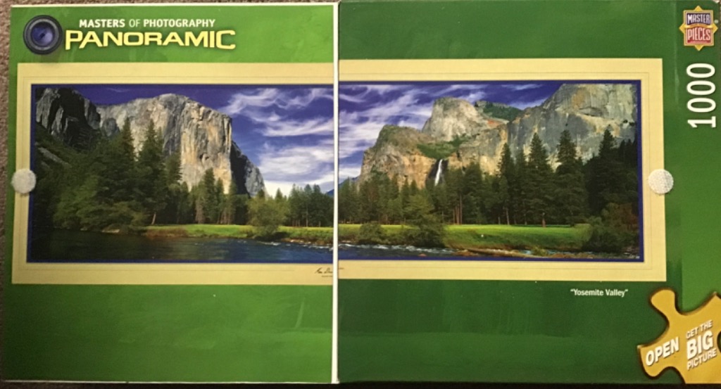 Panoramic Yosemite Valley mountains, river, trees, and waterfall under a blue sky.