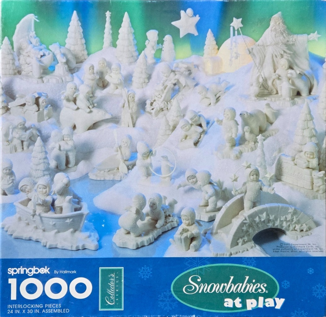 A festive winter scene featuring many small white porcelain-style Snowbabies figurines playing in a snowy landscape.