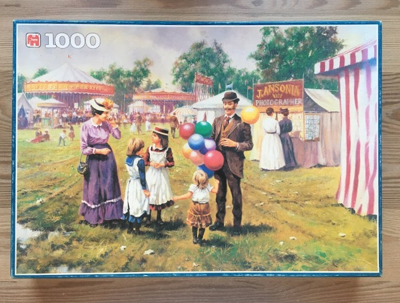 Oil painting of a Victorian-era family at a sunny carnival with a man holding colorful balloons.