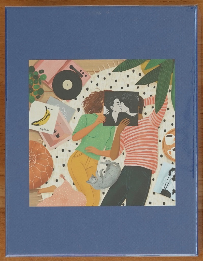 Illustration of a couple lying on a rug holding a square print over their faces, surrounded by records and a cat.
