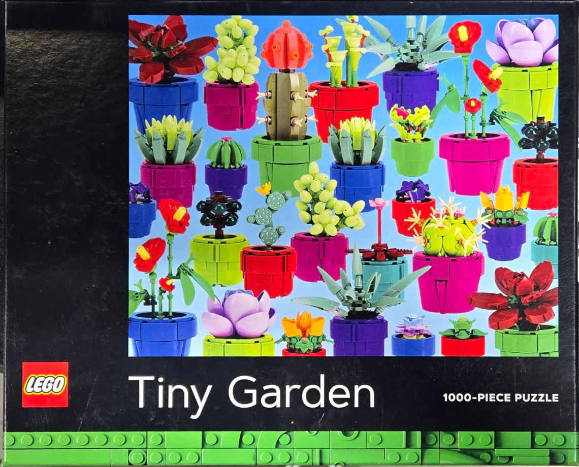 An assortment of colorful buildable toy succulents and cacti in pots against a bright blue background.
