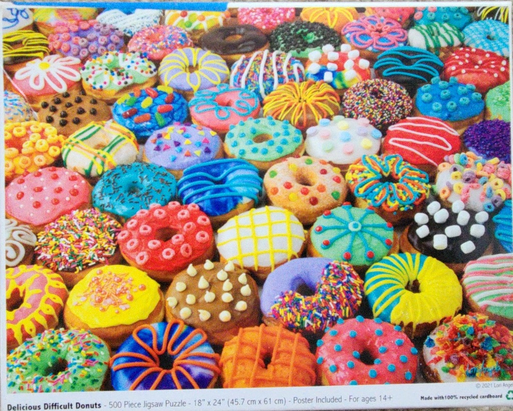 A dense grid of colorful, decorated donuts featuring various icings, sprinkles, and toppings.
