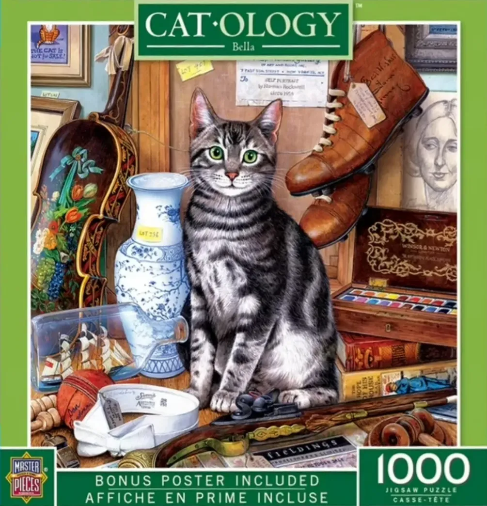 A grey tabby cat sitting among a collection of vintage antiques and art supplies in an attic-like setting.