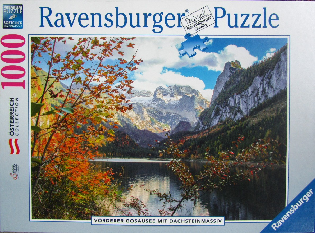 A scenic photograph of the Gosausee lake reflecting the jagged peaks of the Dachstein mountains in autumn.