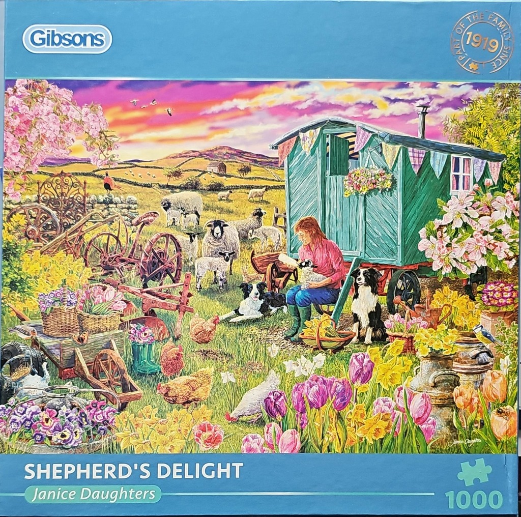 A countryside scene featuring a woman feeding a lamb near a green caravan, surrounded by sheep, dogs, and flowers.