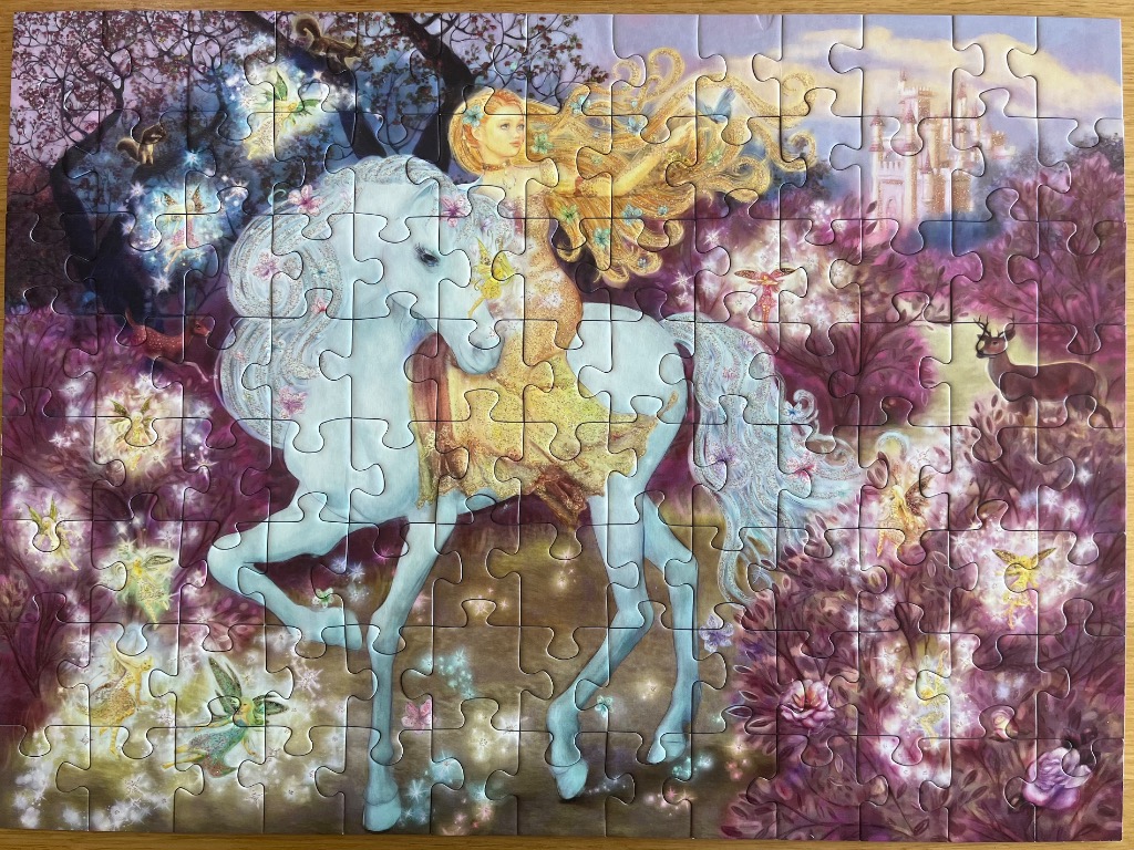 A blonde woman riding a white horse through a magical forest filled with fairies, flowers, and a distant castle.