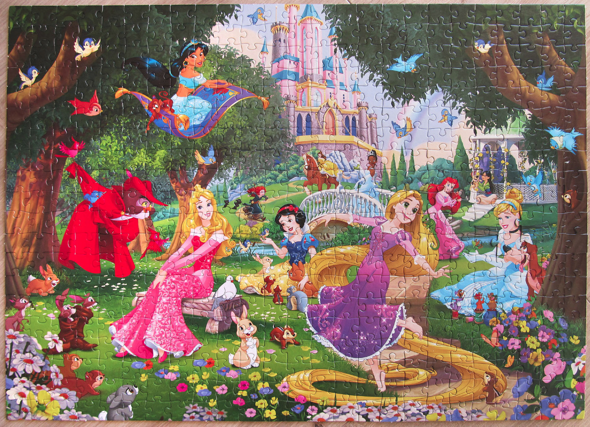 Illustration of multiple Disney princesses gathered in a lush, magical forest with a castle in the background.