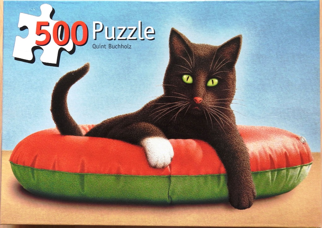 A realistic painting of a black cat with bright green eyes lounging on a red and green inflatable ring.