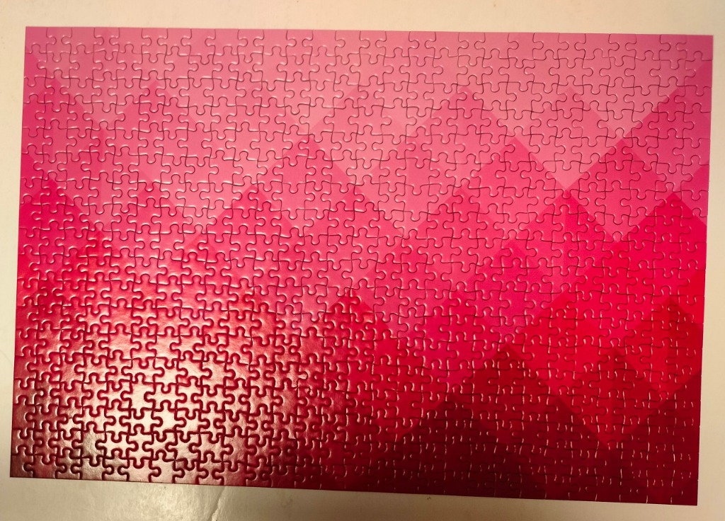 A rectangular graphic design featuring a pink chevron-patterned gradient.