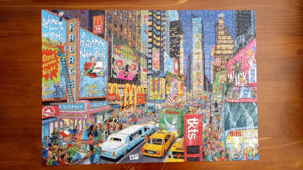 Cartoon illustration of a busy, colourful Times Square scene in New York City with numerous billboards and crowds.