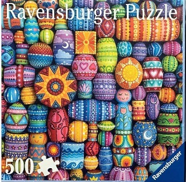 A dense arrangement of brightly painted wooden beads and figurines with intricate patterns.
