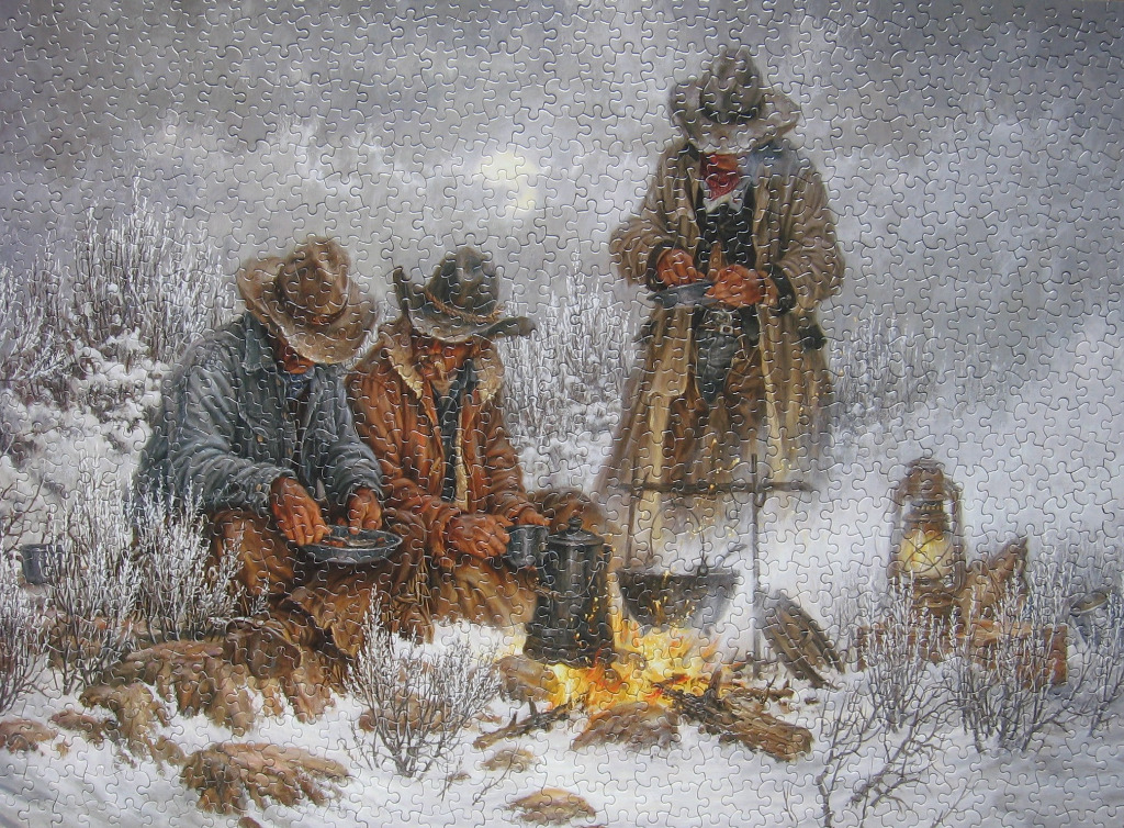 Three cowboys warming themselves by a campfire in a snowy landscape