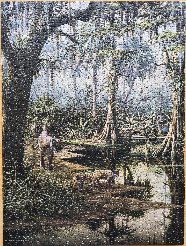A Florida panther and two cubs in a misty, lush swamp setting with cypress trees and Spanish moss.