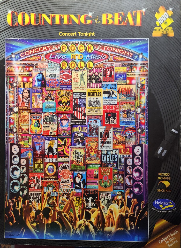 A collage of vintage rock concert posters arranged as a stage backdrop, viewed from a cheering crowd.