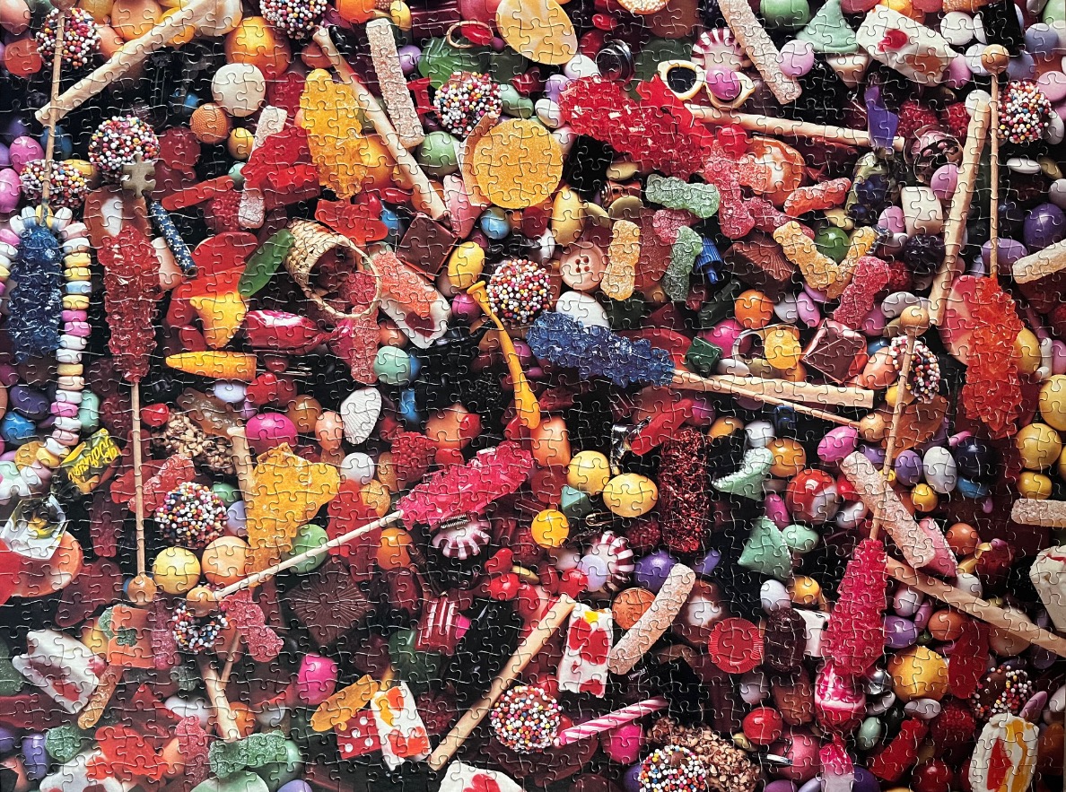 An overhead view of a vibrant, cluttered assortment of various colourful candies.