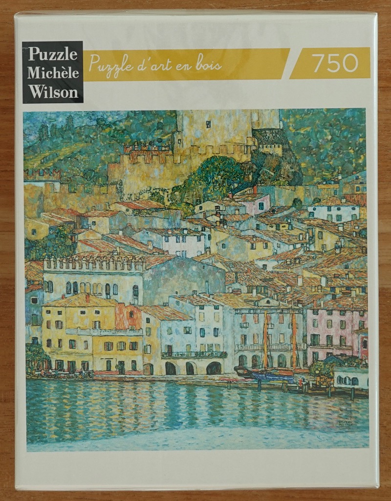 An impressionist painting of a Mediterranean town nestled against a hillside overlooking a calm body of water.