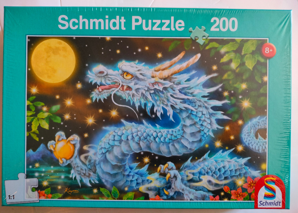 An illustration of a blue, serpentine dragon clutching a glowing orb beneath a full moon in a starry sky.