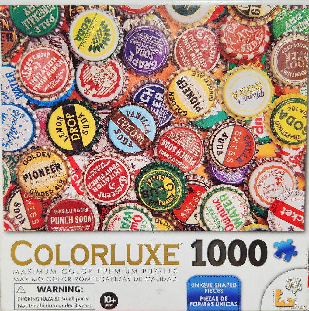 A dense, colorful collage of vintage metal bottle caps of various soda and beverage brands.