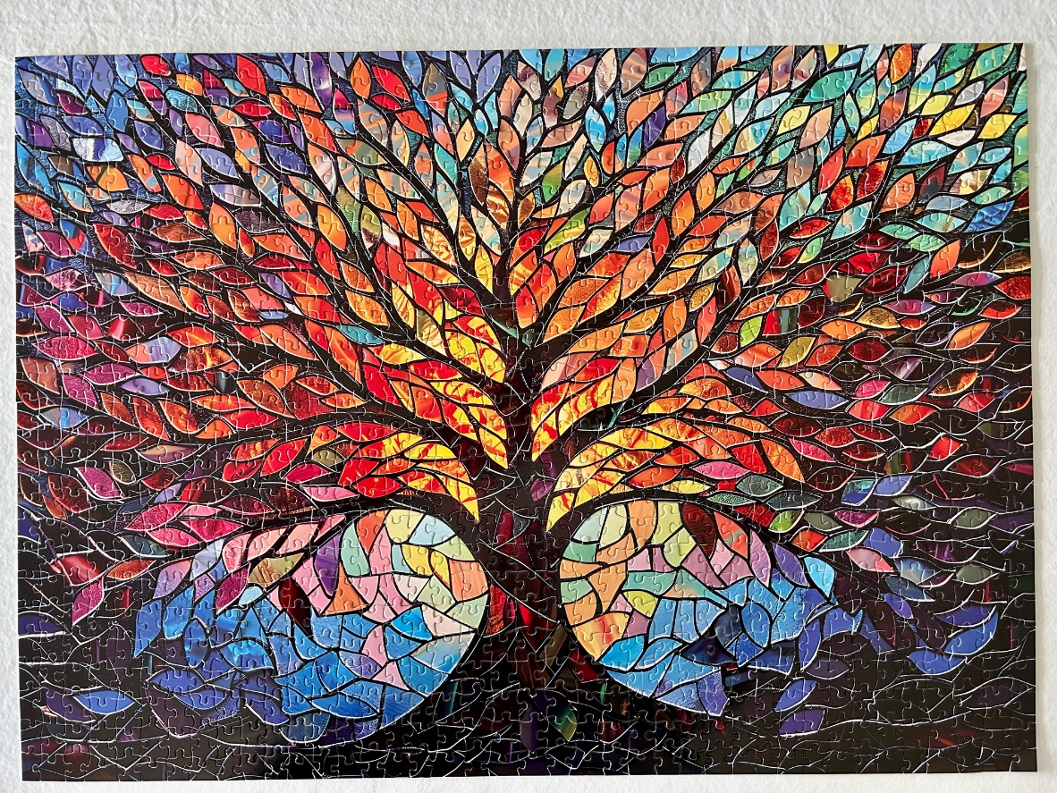 A vibrant mosaic-style tree with colourful, stained-glass inspired leaves against a dark background.