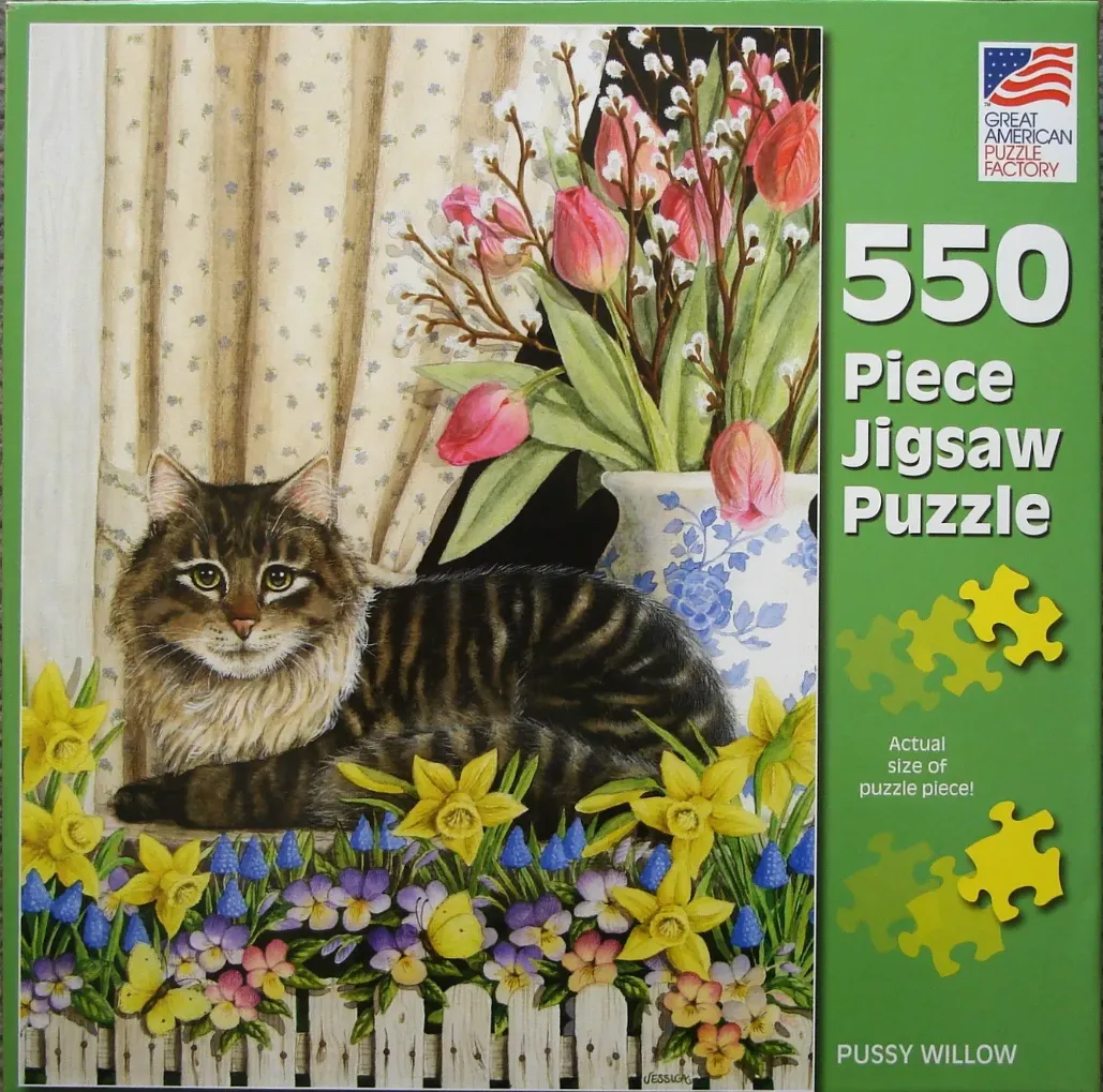 A long-haired tabby cat resting on a windowsill surrounded by spring flowers.