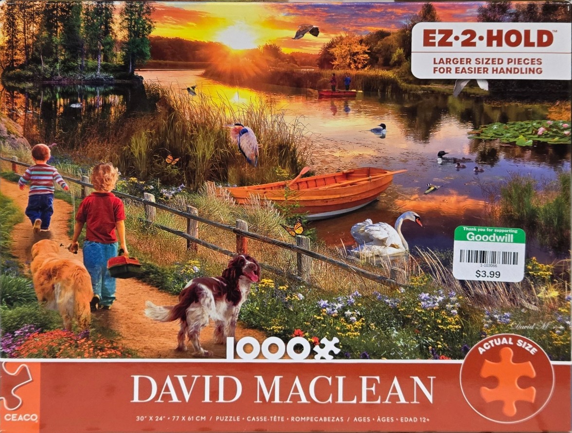 Two children and two dogs on a path by a lake at sunset