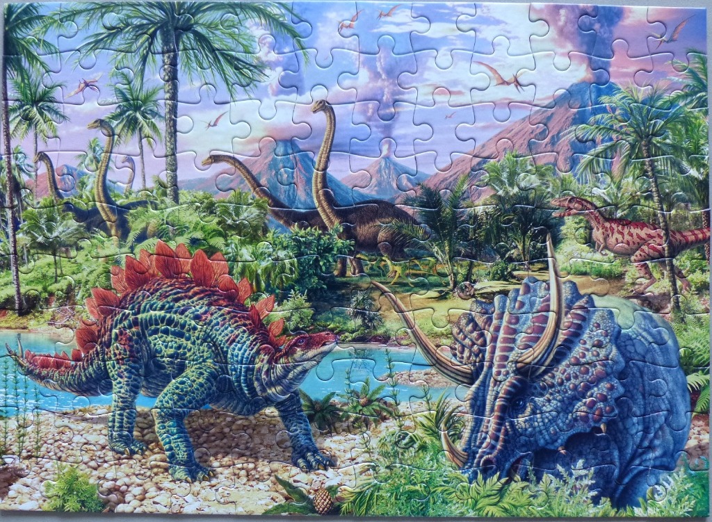 Illustration of various dinosaurs in a prehistoric volcanic landscape