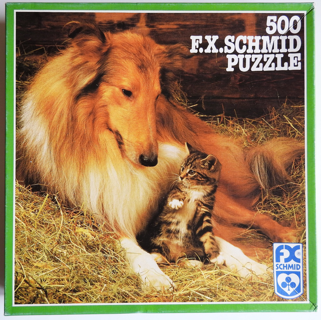 A golden collie dog and a small tabby kitten sitting together in a bed of hay.