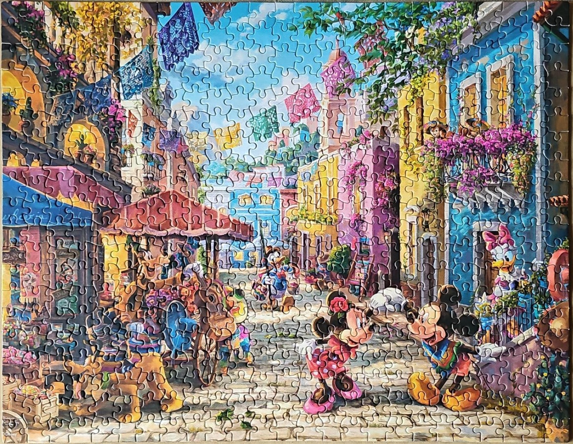 A lively scene in a colorful Mexican-style town featuring Disney characters including Mickey and Minnie Mouse.